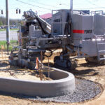 power curber machine creating curb and paving roads