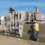 power curber machine creating curb and paving roads