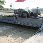 power curber machine creating curb and paving roads