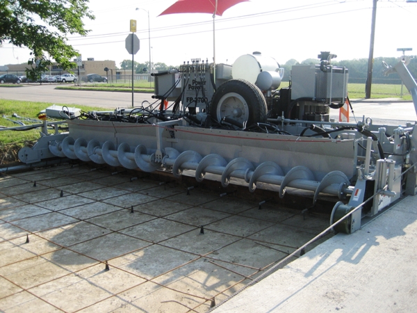 power curber machine creating curb and paving roads