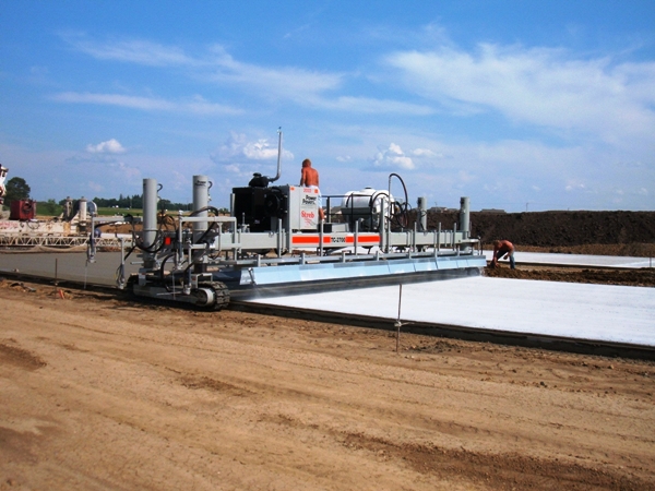 power curber machine creating curb and paving roads