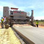 power curber machine creating curb and paving roads