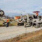 power curber machine creating curb and paving roads