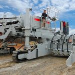 power curber machine creating curb and paving roads