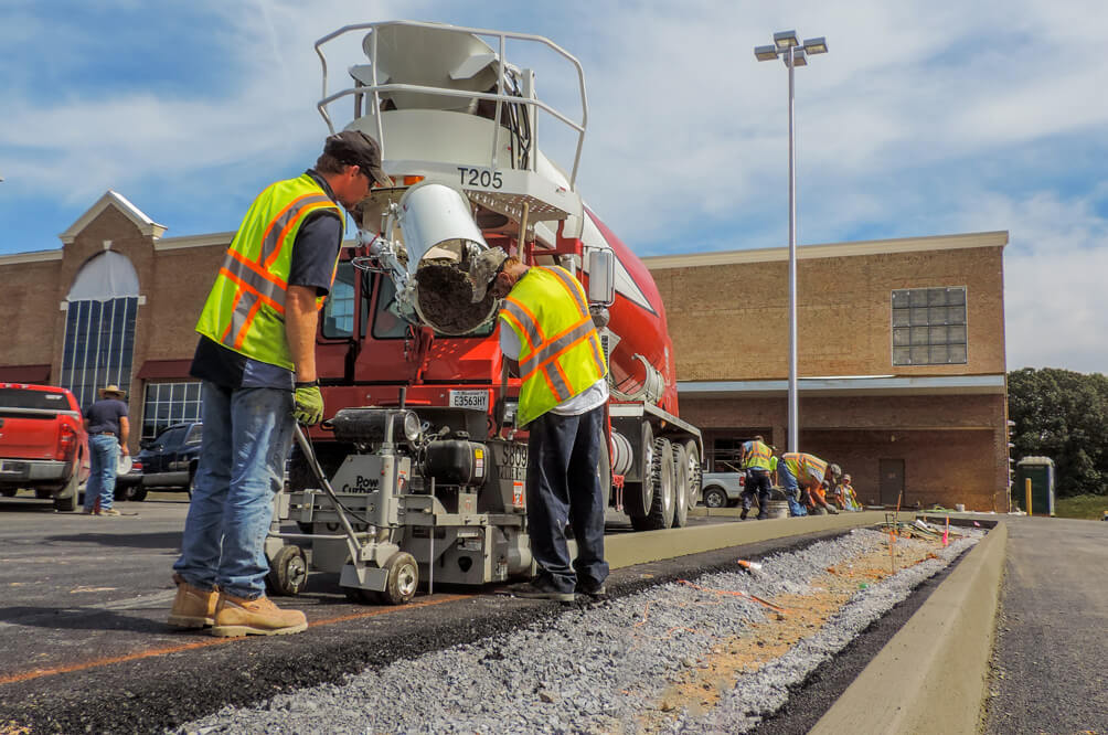 power curber machine creating curb and paving roads