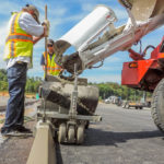 power curber machine creating curb and paving roads