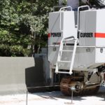 power curber machine creating curb and paving roads