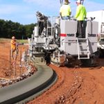 power curber machine creating curb and paving roads