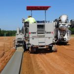 power curber machine creating curb and paving roads