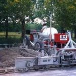 power curber machine creating curb and paving roads