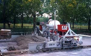 power curber machine creating curb and paving roads