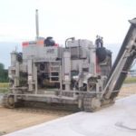 power curber machine creating curb and paving roads