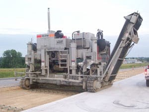 power curber machine creating curb and paving roads