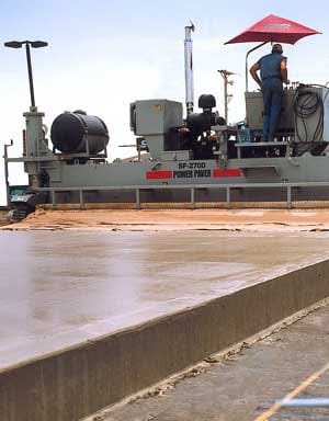 power curber machine creating curb and paving roads