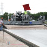 power curber machine creating curb and paving roads