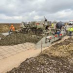 power curber machine creating curb and paving roads