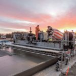 power curber machine creating curb and paving roads