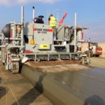 power curber machine creating curb and paving roads