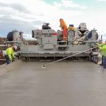 power curber machine creating curb and paving roads