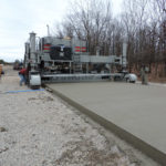 power curber machine creating curb and paving roads