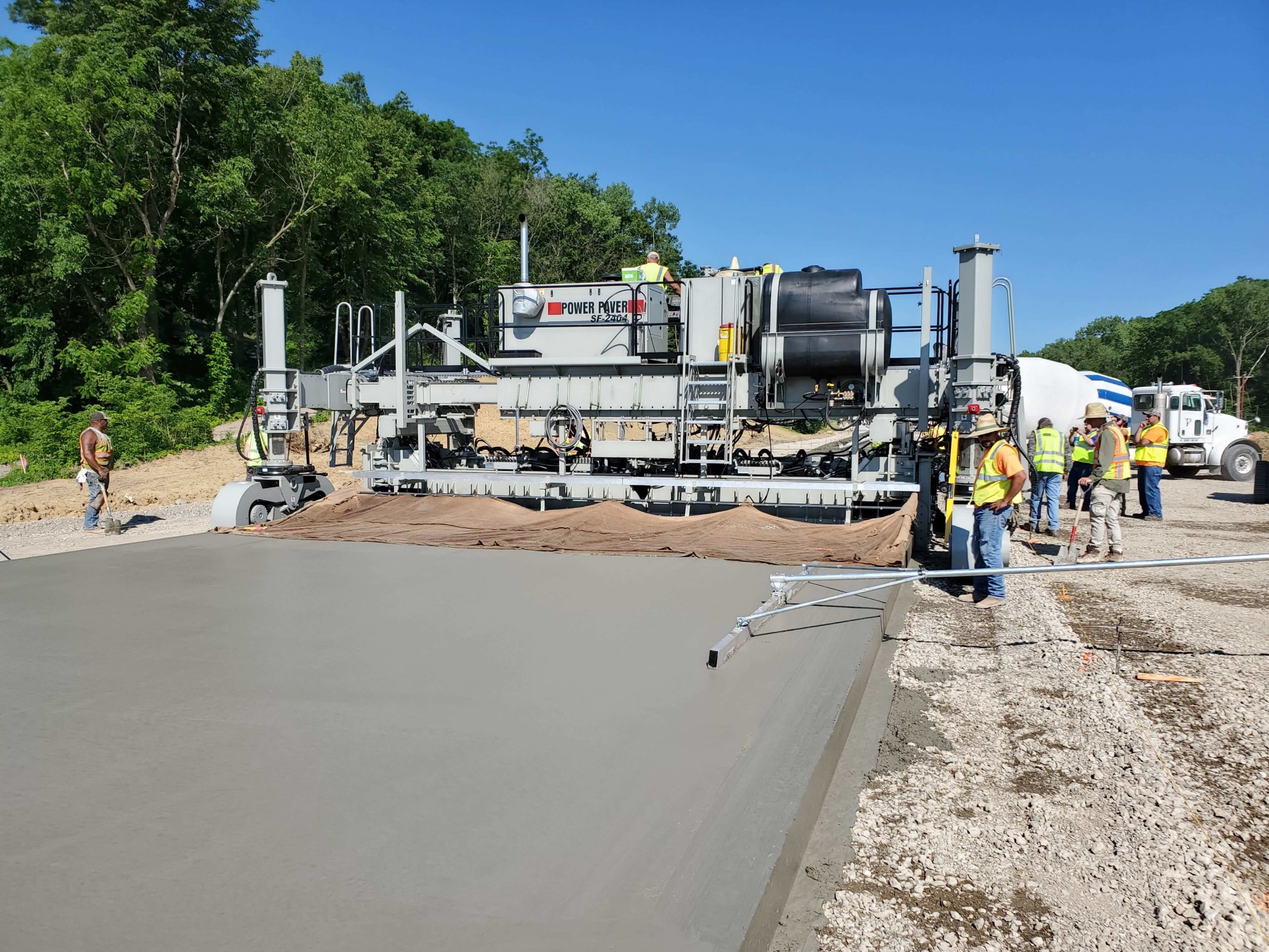 power curber machine creating curb and paving roads