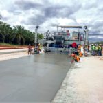 power curber machine creating curb and paving roads