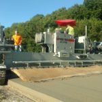 power curber machine creating curb and paving roads