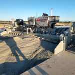 power curber machine creating curb and paving roads