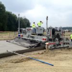 power curber machine creating curb and paving roads