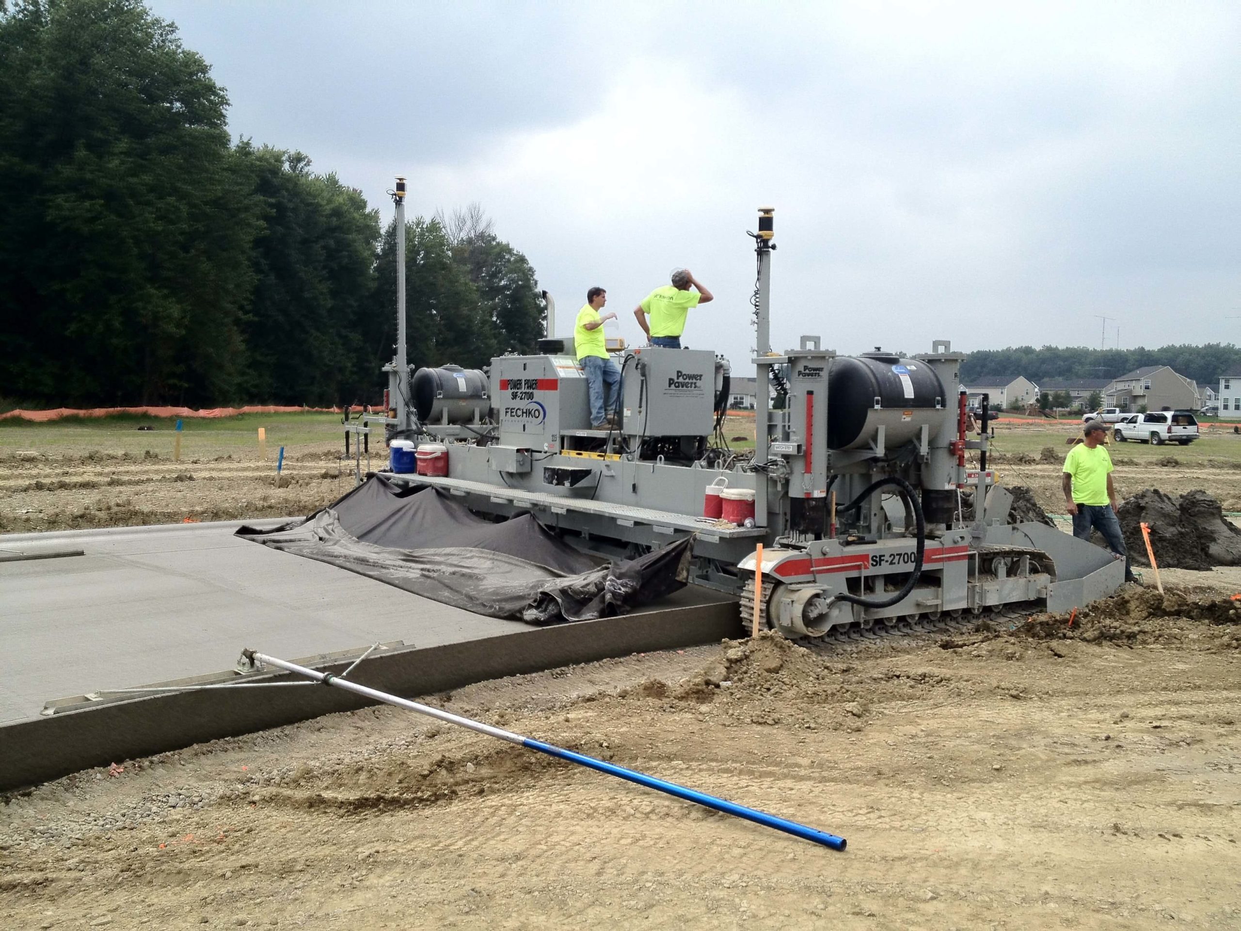 power curber machine creating curb and paving roads