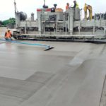 power curber machine creating curb and paving roads