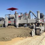 power curber machine creating curb and paving roads