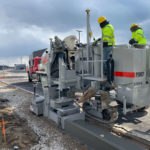 power curber machine creating curb and paving roads