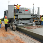 power curber machine creating curb and paving roads