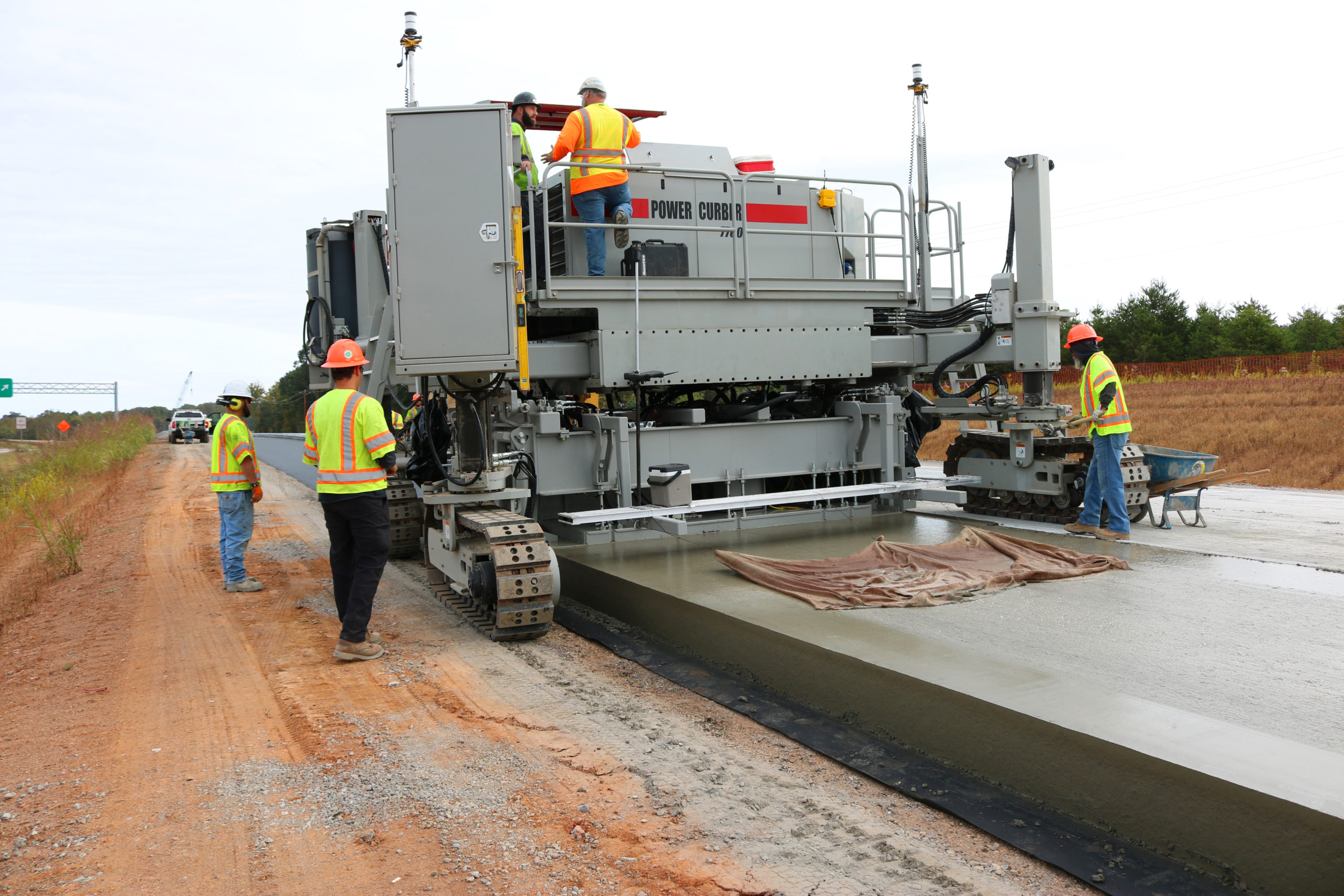 power curber machine creating curb and paving roads