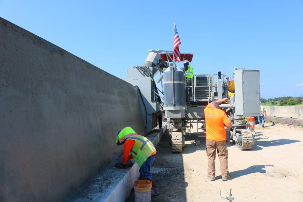 7700 Multipurpose Machine Pouring seven-foot-tall barrier wall