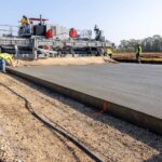 power curber machine creating curb and paving roads