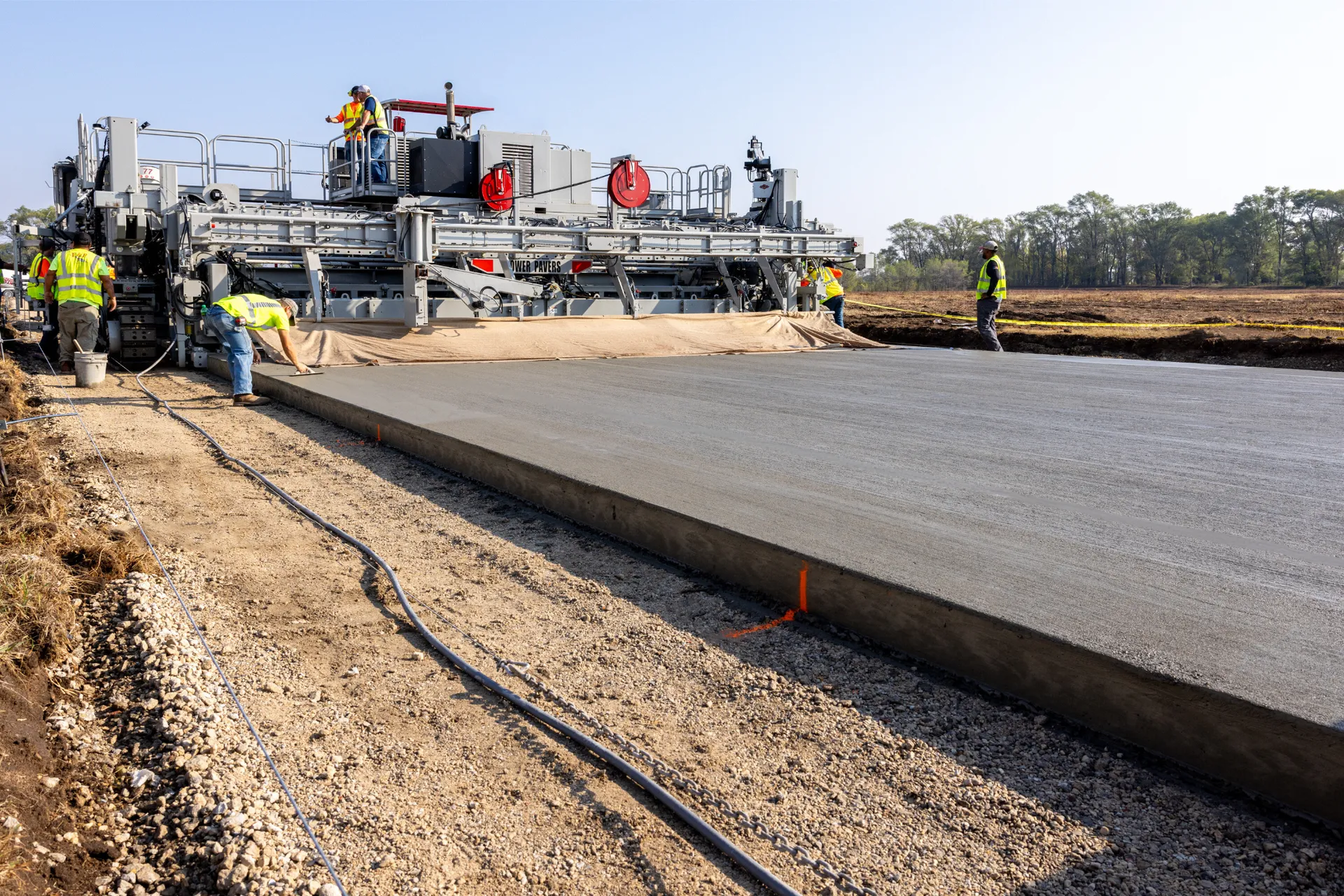 power curber machine creating curb and paving roads