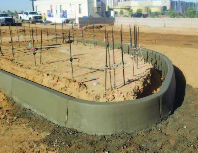 Curved concrete curb foundation form with rebar stakes