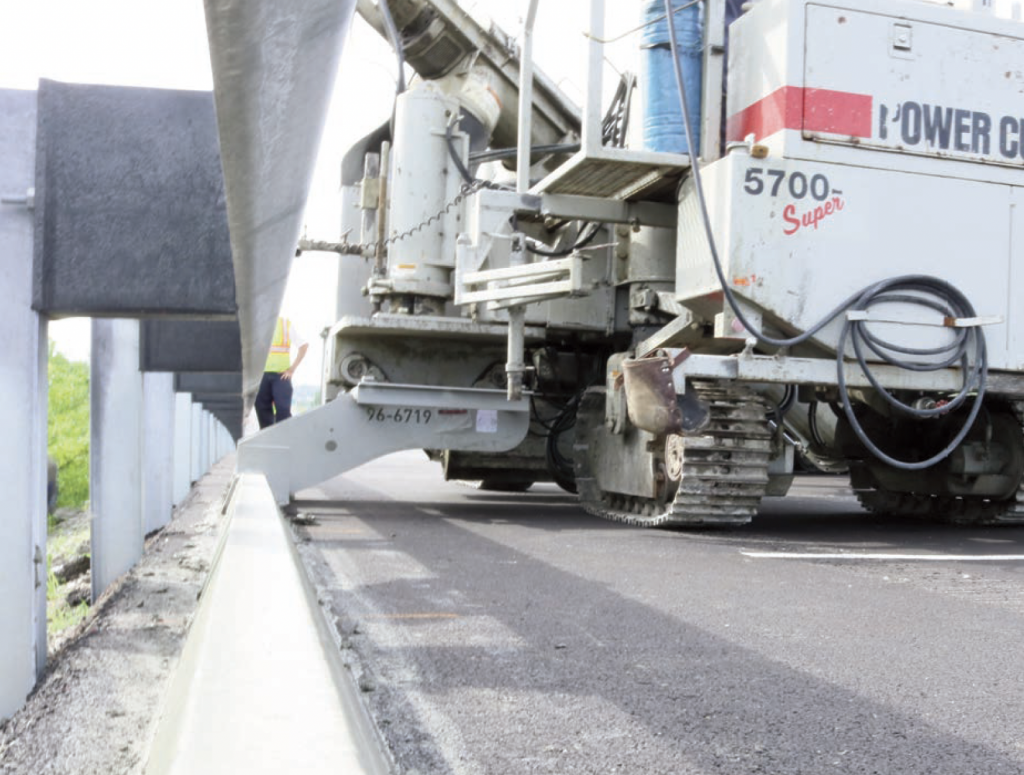 The Illinois Department of Transportation required that the curb be slipformed directly under the guardrail.