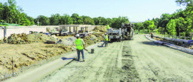 Herrera’s pouring curb and gutter along a new road as part of the Millennium Project