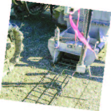 Closeup of reinforcement being fed through to mold