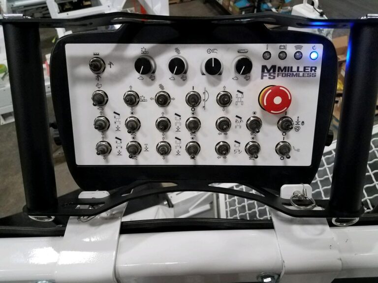 Close-up of the Miller Formless smart control panel with toggle switches, dials, and an emergency stop button.
