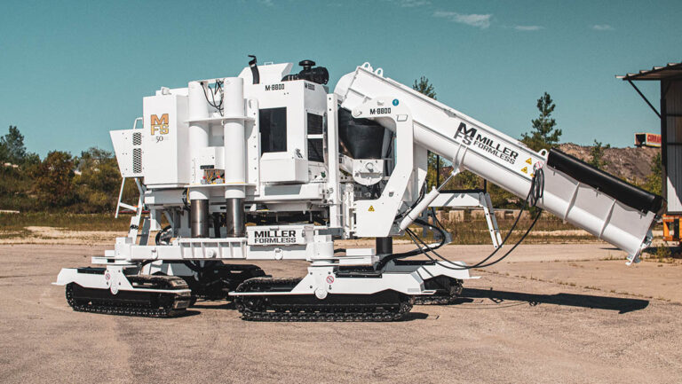 Miller Formless M-8800 machine parked on pavement, showing its full conveyor arm, mold, and tracks.