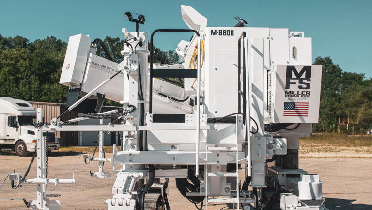 Miller Formless M-8800 machine parked outdoors, showing its mold, MFS badge, and American flag decal beside a semi truck.