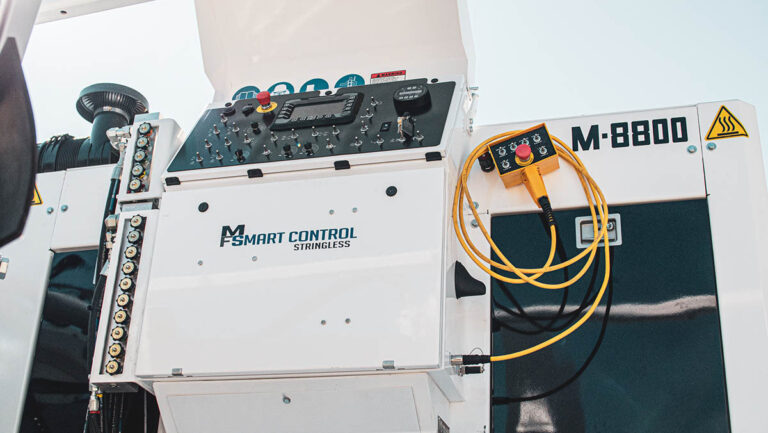 Close-up of the Miller Formless M-8800 Smart Control Stringless panel with a pendant remote control attached.