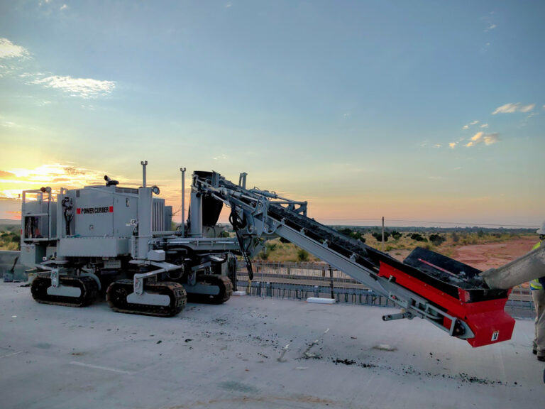Curb machine operating at night