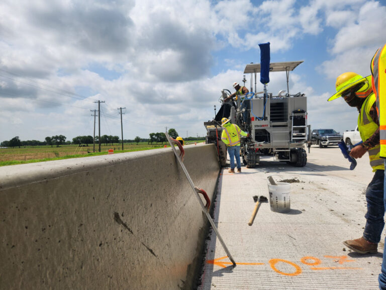 5700-D Max and construction crew creating a barrier