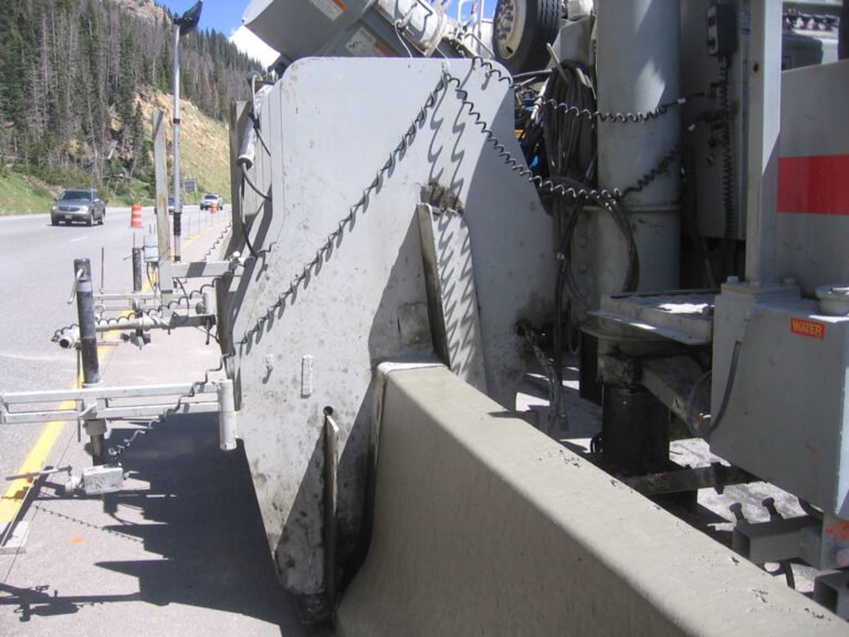 Power Curbers machine laying a highway barrier