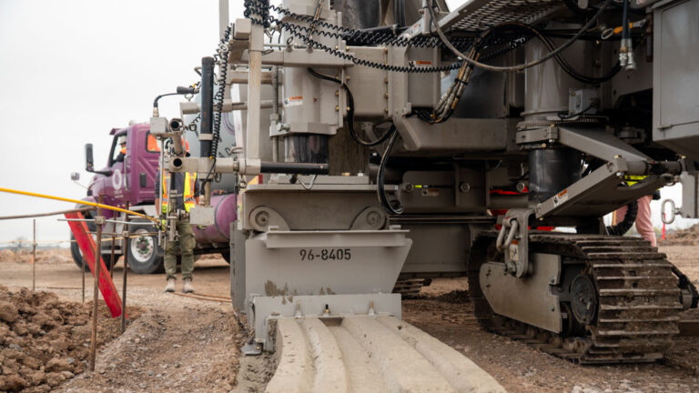 Construction crew laying winding curb